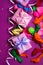 Festive background of purple material colorful balloons streamers confetti box gift Top view flat lay copy space