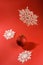 Festive background in red with Christmas ball and snowflakes