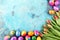 Festive background setting for Easter with eggs and tulips.