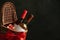 Festive basket with bottles of wine and gift against dark background