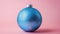 Festive bauble with a vibrant blue snake skin texture, highlighted against a minimalist background of soft lavender