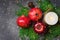 Festive botanical Christmas composition from natural materials fresh green cypress red apples pomegranates pine cones candle