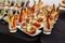 Festive Buffet. An assortment of cold cuts and canapes on wooden skewers. Cocktail reception at the party. catering with