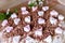 Festive cake with cream and chocolate, decorated with hearts.