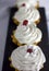 Festive cakes with whipped cream stand in a row on the table