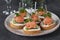 Festive canape with salted salmon, cucumber and soft cheese