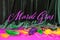 Festive carnival background text Mardi Gras, green velvet curtain colorful feather beads necklace