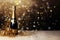 Festive Champagne bottle with glitter, confetti and party streamers on festive background. Happy New Year banner, template,