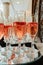 Festive champagne flutes filled with sparkling wine and floating strawberries romantic twinkling party lights