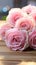 Festive charm Close up of soft pink roses on rustic board
