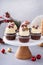 Festive chocolate and orange cupcakes with white chocolate frosting garnished with sugared cranberry