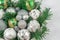 A festive Christmas arrangement artificial branches, glass balls in the basket.