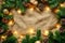 Festive Christmas Background with Twinkling Lights, Pine Branches, and Golden Decorations on a Rustic Textured Surface