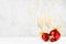 Festive christmas background with two champagne glasses, bright christmas decoration - red balls, golden ribbons, hang curling.