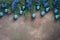 Festive Christmas border of fir branches, blue balls and tinsel on a dark textured rustic background. Top view, flat lay, copy