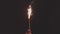 Festive Christmas Roman candle sparkler in hand in the night, vintage toning slow motion