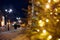 Festive Christmas street decorated with New Year decorations and twinkling garland night lights