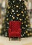 Festive Christmas tree and red armchair.