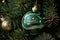 Festive Christmas tree toy ball with drawing green snake close up on a background of fir branch