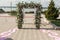 A festive chuppah decorated with fresh beautiful flowers for an outdoor wedding ceremony