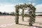 A festive chuppah decorated with fresh beautiful flowers for an outdoor wedding ceremony