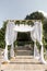 A festive chuppah decorated with fresh beautiful flowers for an outdoor wedding ceremony