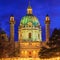 Festive cityscape - view of the Karlskirche St. Charles Church and the Christmas Market on Karlsplatz Charles` Square in the c