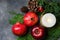 Festive colorful botanical Christmas composition from natural materials. Green juniper red apples pomegranates pine cones candle