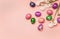 Festive composition, colorful Easter eggs and daffodils on a pink background, place for the text