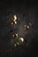 Festive composition of golden balls and ornaments, shiny ornament on a dark background. New Year and Christmas concept. Levitation