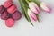 Festive composition, tulips and macaroons on the table