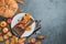 Festive, culinary, autumn background with a white plate, autumn leaves and a pumpkin.