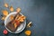 Festive, culinary background. Plates, napkin, autumn leaves on a gray-blue background.