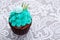 Festive cupcake with mint frosting, rosemary , macaron