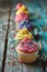 Festive cupcakes with multicolored frosting and candy sprinkles