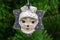 Festive decoration in the shape of a leveret mask, on a Christmas tree background