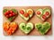 Festive delicious bread toasts with various vegetables, heart-shaped, on a wooden board