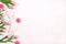 Festive dental background with teeth, bows and pink tulips on a white background with copy space for text