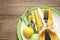 Festive Easter table setting with beautiful narcissus and painted eggs, top view