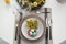 Festive Easter table setting with floral decor and eggs, flat lay