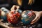 Festive factory job: woman crafting Christmas balls