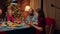 Festive family members gathered around Christmas dinner table