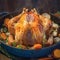 Festive feast Roast turkey or chicken in an old pan with vegetables
