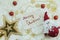 festive flat lay composition with golden star and Santa Claus toy with note merry Christmas on a white blanlet