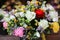 Festive flower arrangement of white roses and eustoma, colorful persian buttercup flowers and other plants