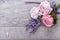 Festive flower English roses composition with ribbon, lavender on wooden background, rustic style. Overhead top view