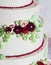 Festive four-level white elegant cake with cream flowers, wedding cake, cream flowers in the Malaysian technique