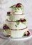 Festive four-level white elegant cake with cream flowers, wedding cake, cream flowers in the Malaysian technique