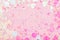 Festive frame of colorful Confetti and sparkles on pink pastel trendy background.