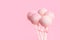 Festive glazed cake pops over pink background with copy space, c